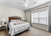 Thumbnail 25 of 40 - a bedroom with a large window and a bed