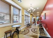Thumbnail 31 of 40 - a dining area with tables and chairs and large windows