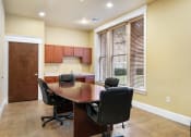 Thumbnail 30 of 40 - a conference room with a wooden table and chairs