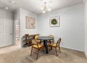 Thumbnail 23 of 40 - a dining room with a table and chairs and a door