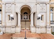 Thumbnail 19 of 40 - the front of a white building with stairs and an arch