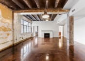 Thumbnail 11 of 40 - an empty living room with white walls and a fireplace