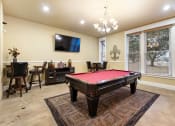 Thumbnail 29 of 40 - a game room with a pool table and a tv