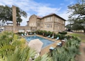 Thumbnail 1 of 40 - a swimming pool in front of a brick building
