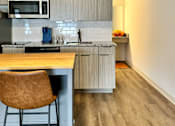 Thumbnail 9 of 21 - a kitchen with a island and a stove and a microwave at The Teale Navy Yard, North Charleston, 29405