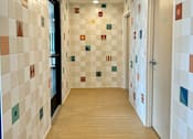 Thumbnail 8 of 21 - a hallway with a wood floor and tiles on the walls and a door at The Teale Navy Yard, North Charleston, SC, 29405