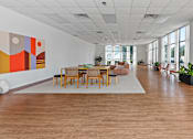 Thumbnail 12 of 16 - A room with a large painting on the wall and wooden flooring at The Teale Siesta Lago in Kissimmee, FL, 34746