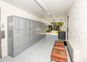 Thumbnail 10 of 11 - a locker room with a bench and some lockers at The Teale, Kissimmee, FL, 34746