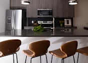 Thumbnail 5 of 38 - a kitchen with a counter and chairs and a refrigerator  at The Lady, Columbia, 29201