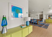 Thumbnail 11 of 20 - A modern living room with a yellow sideboard and a blue lamp.
