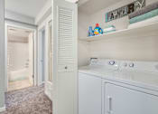 Thumbnail 10 of 25 - A laundry room with a washer and dryer.