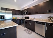 Thumbnail 2 of 36 - Kitchen at Living room at Southfield MI Apartments | 42 West Apartments in Southfield Michigan