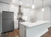 Thumbnail 6 of 47 - White kitchen in apartments in Traverse City | Bayview of Traverse City