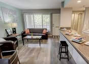 Thumbnail 2 of 34 - A kitchen with a table and chairs in the middle of the room.