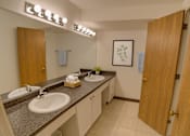Thumbnail 13 of 20 - A bathroom with two sinks and a mirror.