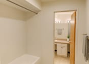 Thumbnail 15 of 20 - A white bathroom with a mirror and a white sink.
