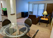 Thumbnail 8 of 24 - a living room with a glass table and a couch