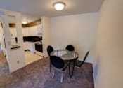 Thumbnail 10 of 24 - a dining room with a table and chairs and a kitchen