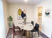 Thumbnail 12 of 12 - a dining room with a table and chairs