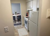 Thumbnail 8 of 12 - a kitchen with a refrigerator and a stove and a dining room