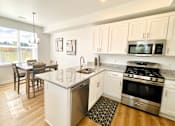 Thumbnail 11 of 43 - Kitchen in townhome at Elmwood Lake Apartments in Hudsonville MI