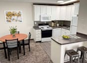 Thumbnail 1 of 9 - a kitchen with white cabinets and a table and chairs