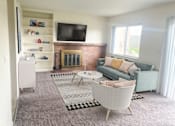 Thumbnail 3 of 9 - Spacious living room in East Lansing Apartments near Michigan State University | Holiday Townhomes