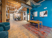 Thumbnail 18 of 26 - a large room with blue walls and a wooden table in the middle of the room