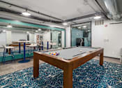 Thumbnail 17 of 26 - a pool table sits in the middle of a room with a bar in the background