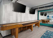 Thumbnail 20 of 26 - a games room with a shuffleboard table and two televisions