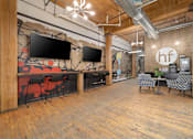 Thumbnail 16 of 26 - a large open space with wood floors and a mural on the wall