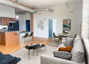 Thumbnail 2 of 26 - an open living room and kitchen area with a couch table and chairs and a kitchen with a