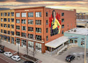 Thumbnail 1 of 26 - a mural of a woman on the side of a building