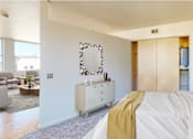 Thumbnail 13 of 50 - a bedroom with a bed and a dresser