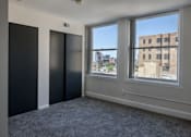Thumbnail 2 of 50 - an empty room with a window and three doors