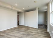 Thumbnail 47 of 50 - a living room with white walls and a wooden floor