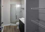 Thumbnail 35 of 50 - a bathroom with a shower and a sink and a toilet