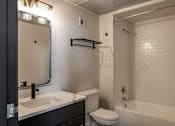 Thumbnail 48 of 50 - a bathroom with a sink and a toilet and a bath tub