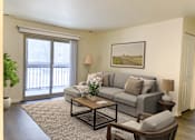Thumbnail 9 of 34 - a living room with a couch and a coffee table