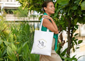 Thumbnail 46 of 47 - Woman carrying bag at Royal Oak, MI Apartments | Main Living Apartments in Royal Oaks, MI