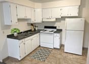 Thumbnail 1 of 13 - a kitchen with white appliances and white cabinets
