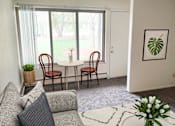 Thumbnail 6 of 15 - Living room and dining in Okemos Village Apartments in Okemos, MI