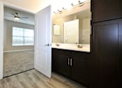 Thumbnail 12 of 26 - a bathroom with a sink and a mirror