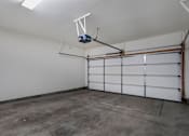 Thumbnail 13 of 26 - the interior of a garage with white walls and a concrete floor