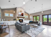 Thumbnail 14 of 26 - a living room with couches and a coffee table in front of a fireplace