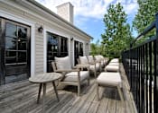 Thumbnail 20 of 26 - a deck with chairs and stools on a sunny day
