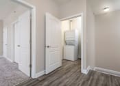Thumbnail 7 of 26 - a bedroom with a washer and dryer