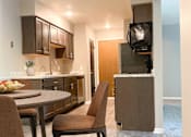 Thumbnail 2 of 9 - Kitchen and dining at Summerhill Estates Apartments in Lansing, MI