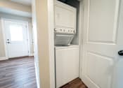 Thumbnail 13 of 27 - A white door is open to a small kitchen with a dishwasher and oven.