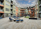 Thumbnail 26 of 35 - Resident courtyard with grills, putting green and hot tub | Vista at the Heights Apartments in Lansing MI